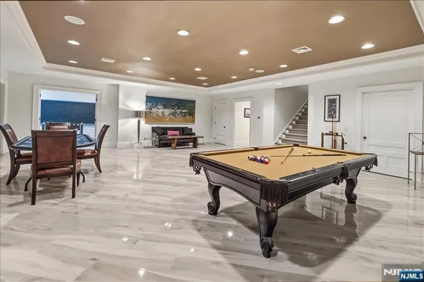 a living room with furniture a table and kitchen view