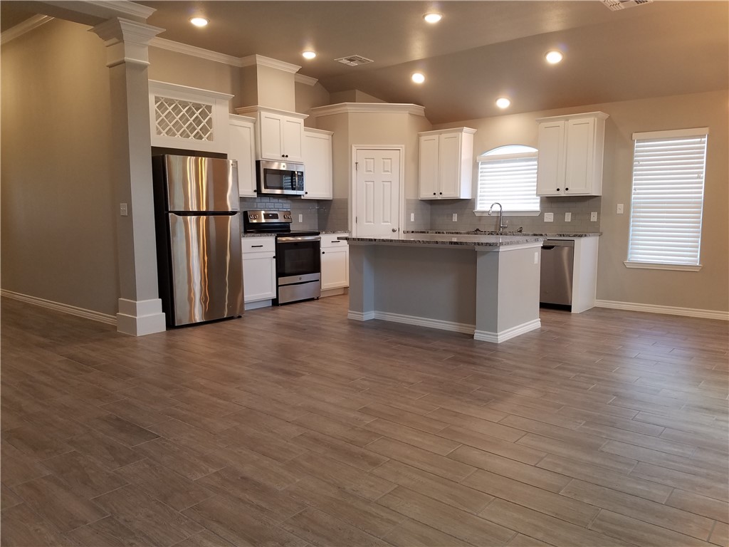 7202 Bryson Way Corpus Christi, TX 78414 - Photo 2 of 12 a kitchen with stainless steel appliances granite countertop a refrigerator and a stove top oven