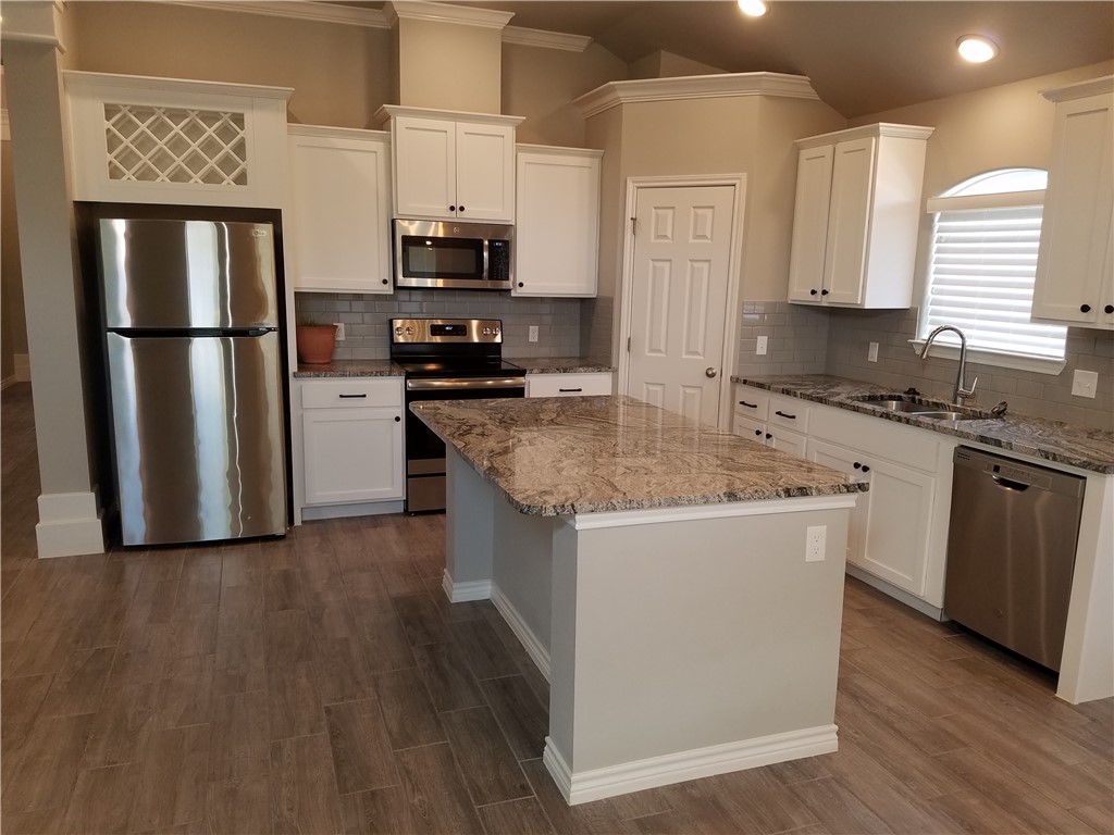 7202 Bryson Way Corpus Christi, TX 78414 - Photo 4 of 12 a kitchen with stainless steel appliances granite countertop a sink stove microwave and refrigerator
