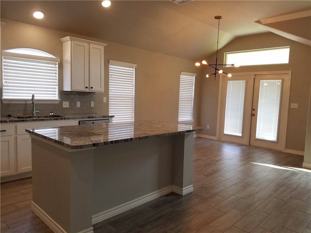 7202 Bryson Way Corpus Christi, TX 78414 - Photo 5 of 12 a kitchen with stainless steel appliances granite countertop a sink a stove and a wooden floor