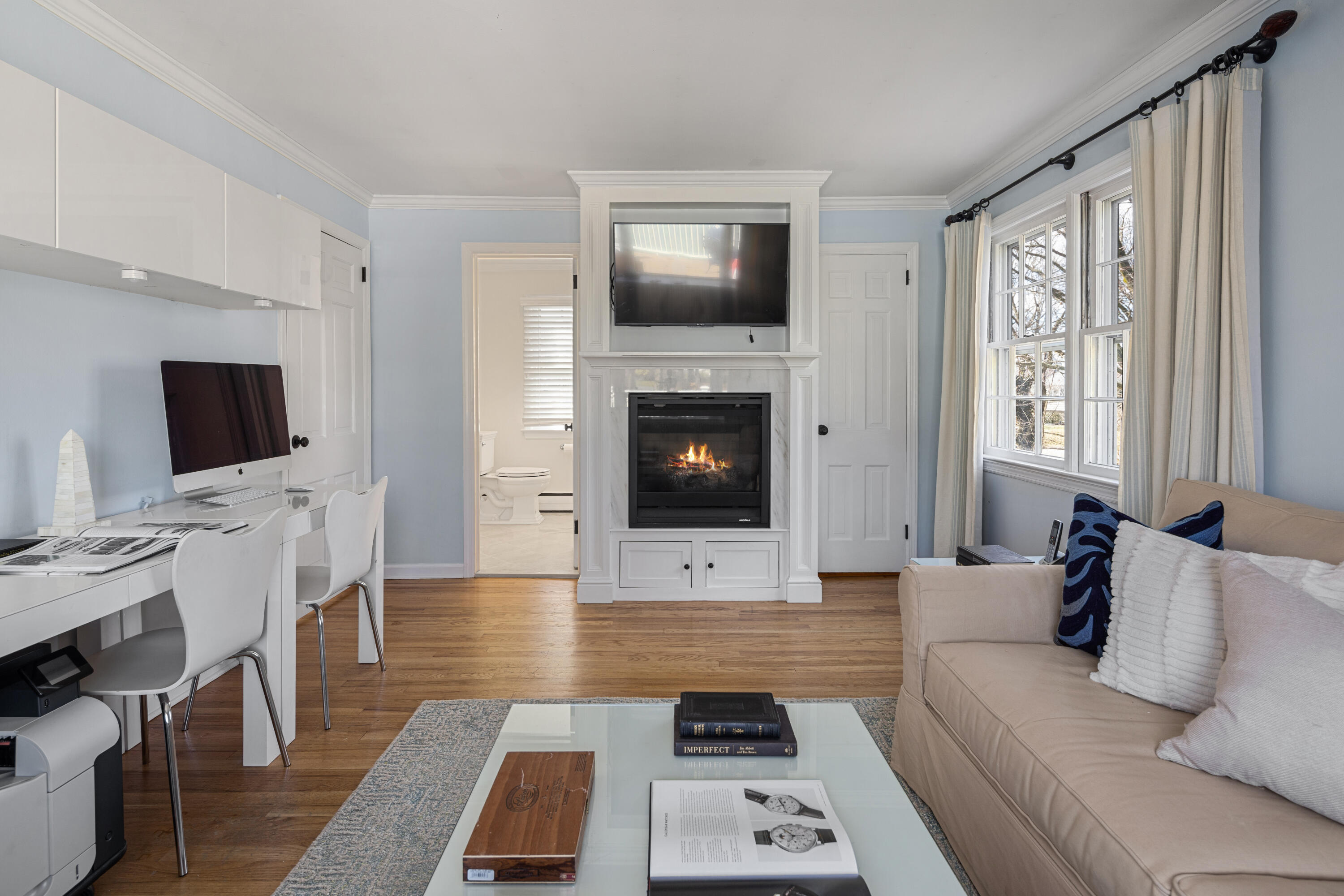 9 Duffy's Lane Darien, CT 06820 - Photo 20 of 42 a living room with furniture a flat screen tv and a fireplace