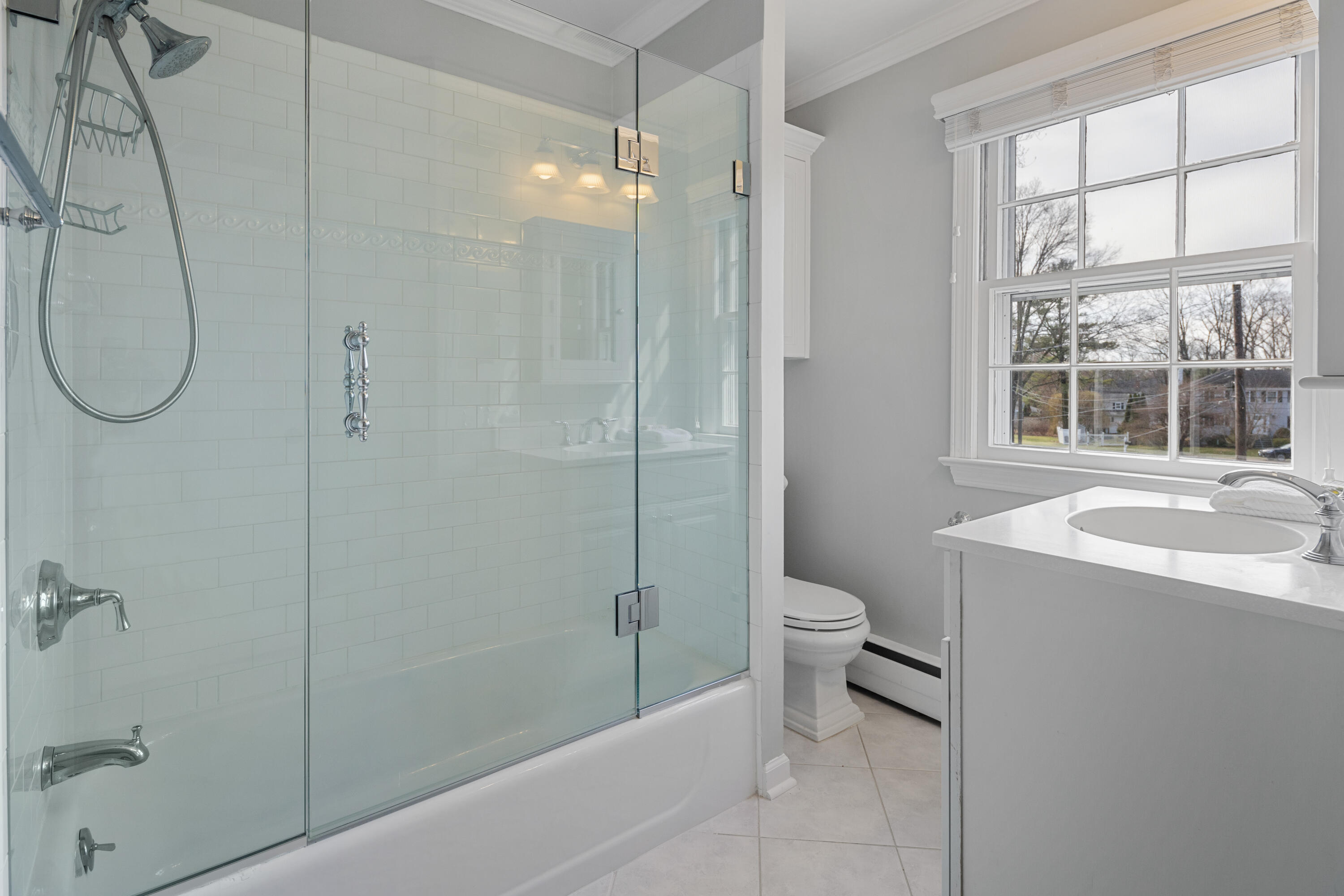 9 Duffy's Lane Darien, CT 06820 - Photo 28 of 42 a bathroom with a granite countertop toilet a sink and shower