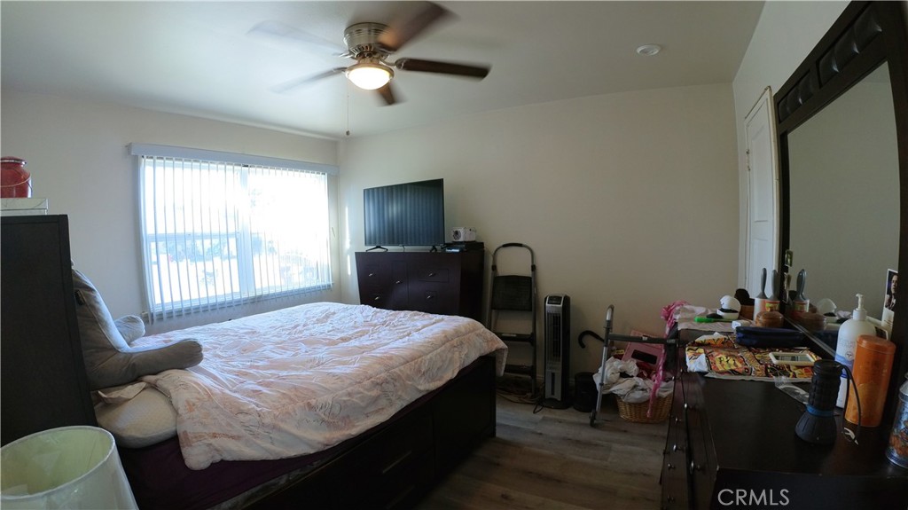 1808 North Grape Avenue Compton, CA 90222 - Photo 22 of 35 a bedroom with a bed gym equipment and a window