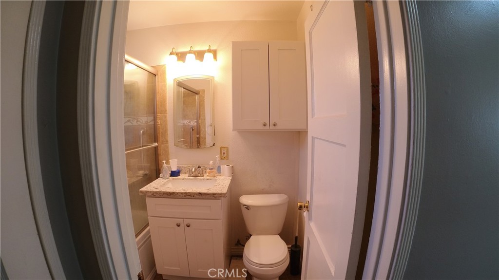 1808 North Grape Avenue Compton, CA 90222 - Photo 30 of 35 a bathroom with a sink vanity mirror and toilet