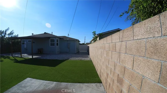 a view of a house with a yard and a porch