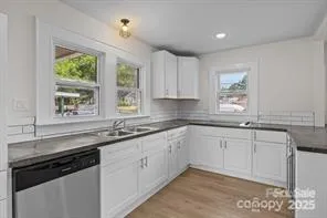 a kitchen with granite countertop a sink and cabinets
