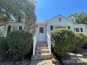 a house that has a tree in front of it