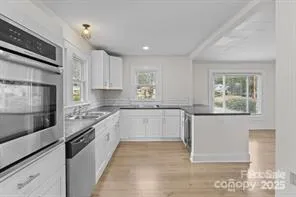 an empty room with window and wooden floor