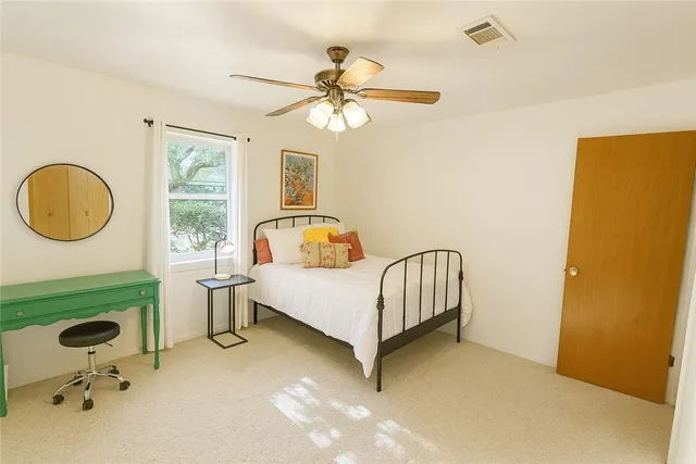 a bedroom with a bed and window