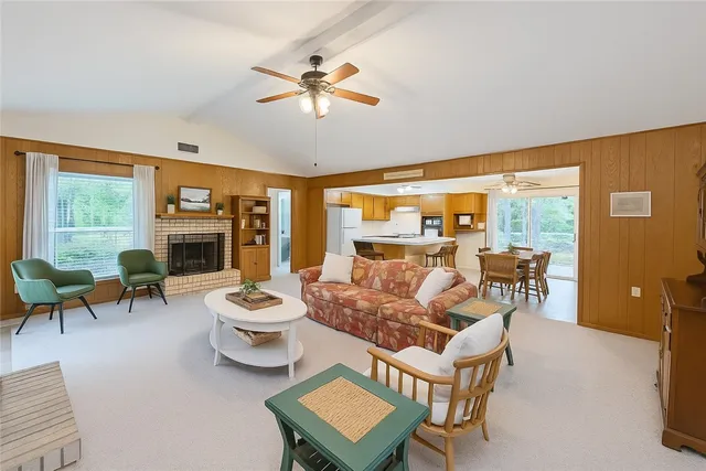 a living room with furniture a large window and a table