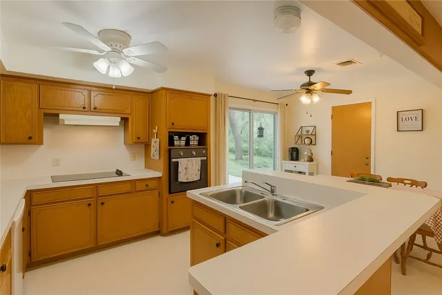 a kitchen that has a sink and cabinets