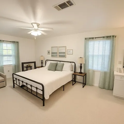 a spacious bedroom with a bed and a window