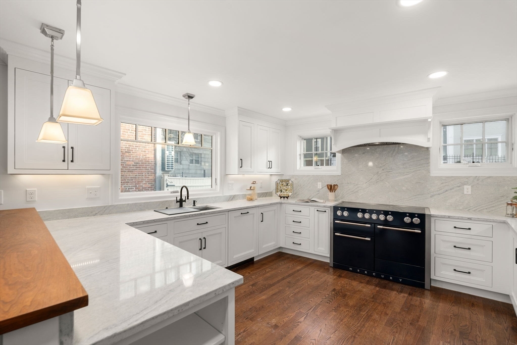 10 Bartlett Street Boston, MA 02129 - Photo 1 of 34 a kitchen with a sink stove top oven and cabinets