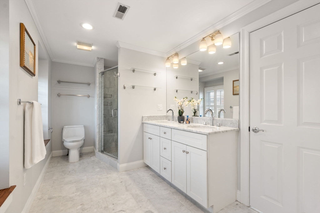 10 Bartlett Street Boston, MA 02129 - Photo 17 of 34 a bathroom with a double vanity sink mirror and toilet