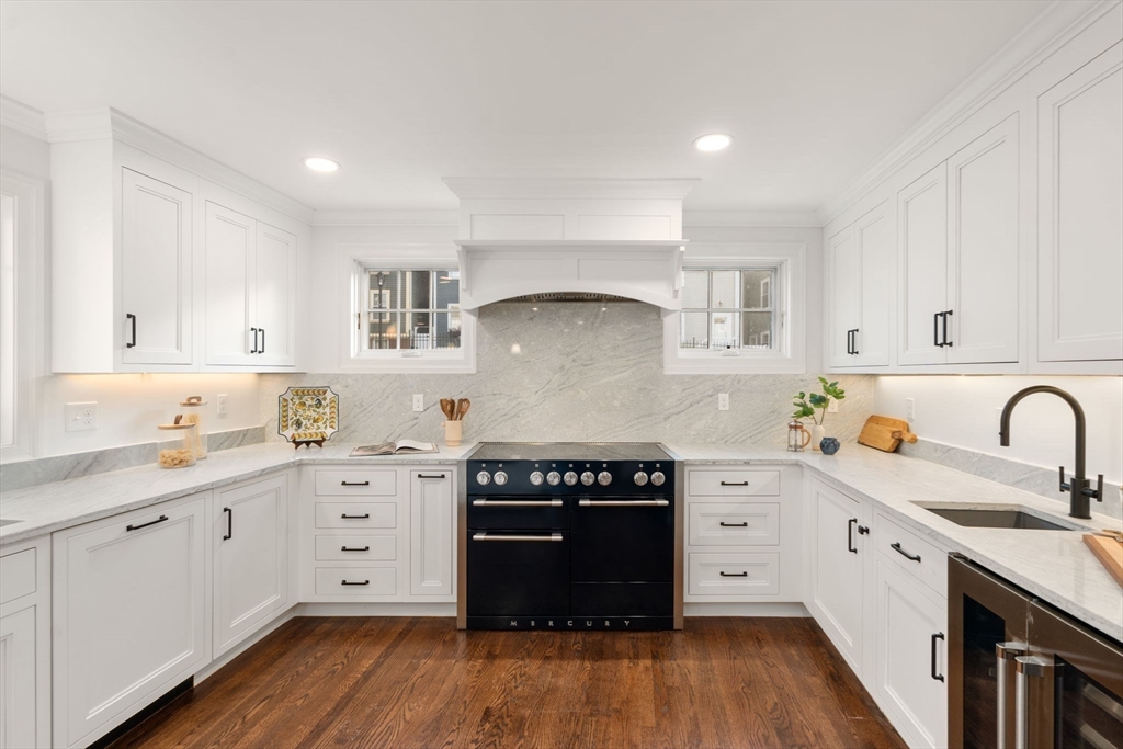 10 Bartlett Street Boston, MA 02129 - Photo 2 of 34 a kitchen with a stove top oven sink and cabinets