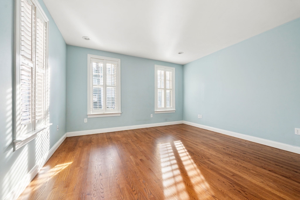 10 Bartlett Street Boston, MA 02129 - Photo 21 of 34 a view of an empty room with wooden floor and a window