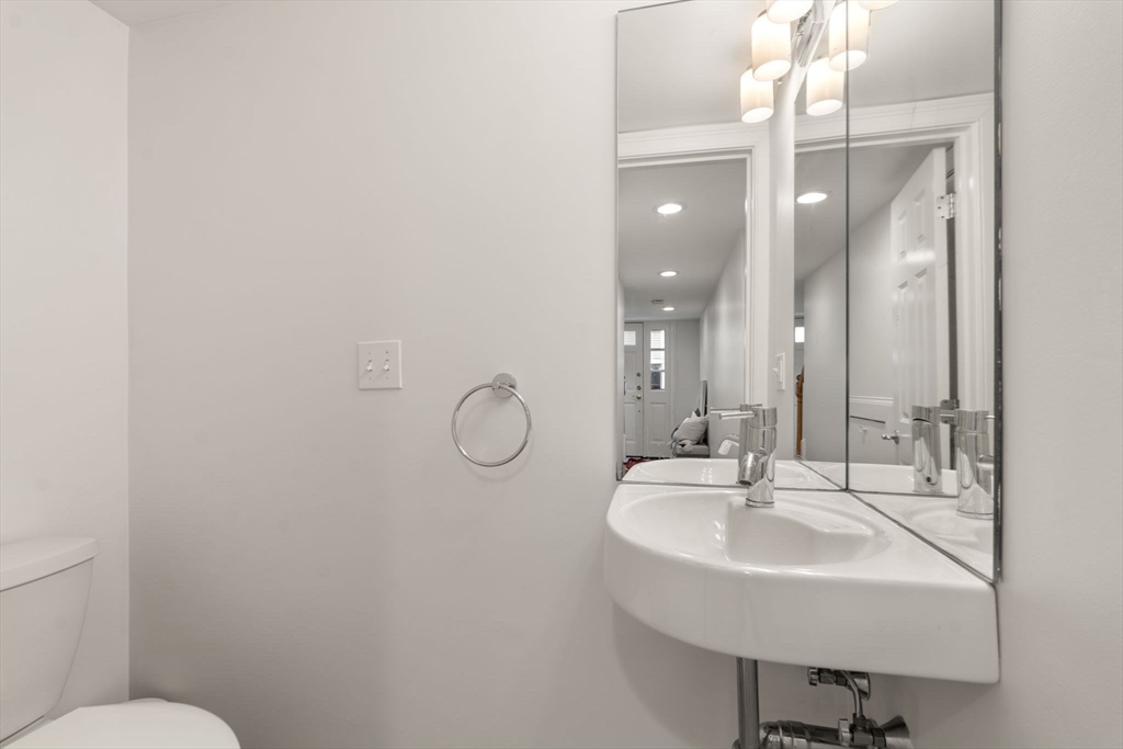 10 Bartlett Street Boston, MA 02129 - Photo 23 of 34 a bathroom with a sink mirror and toilet