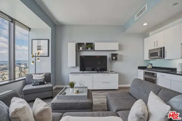 a living room with furniture and a flat screen tv