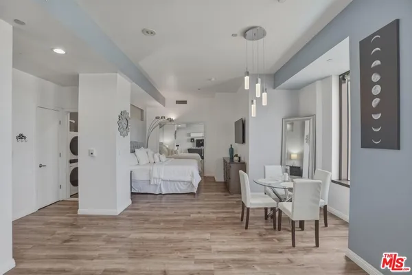 a living room with furniture and a dining table with kitchen view