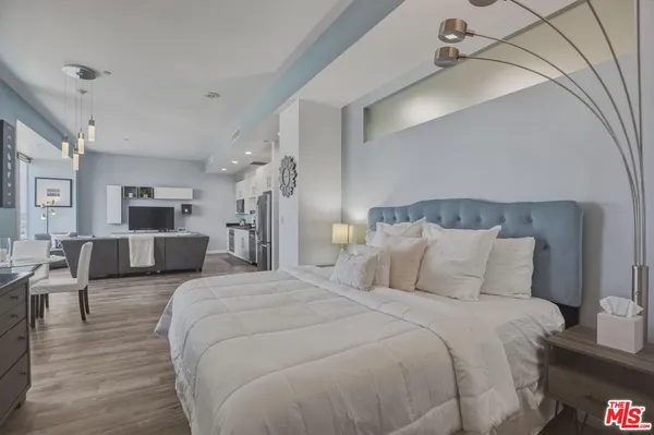 a bedroom with bed and a chandelier
