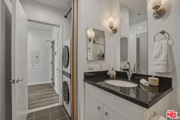 a bathroom with a granite countertop sink and a mirror