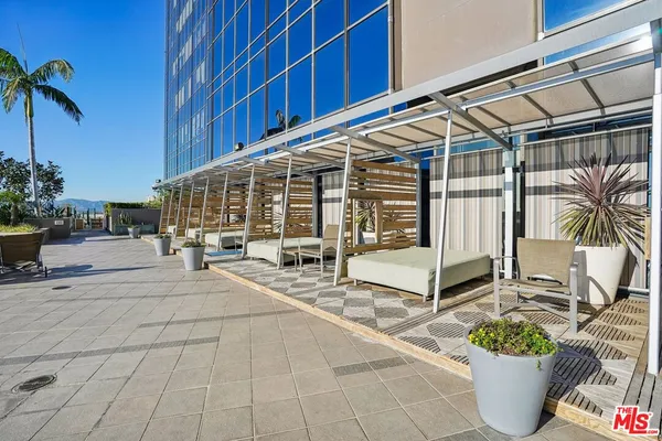 a building with potted plants in front of door