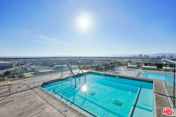 a view of a swimming pool with outdoor seating and a terrace