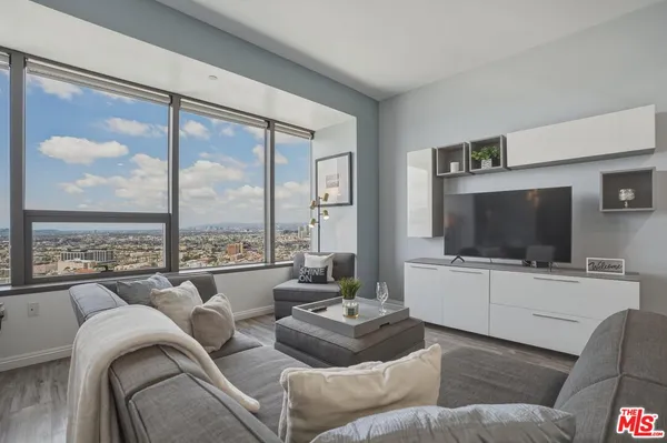 a living room with furniture and a flat screen tv