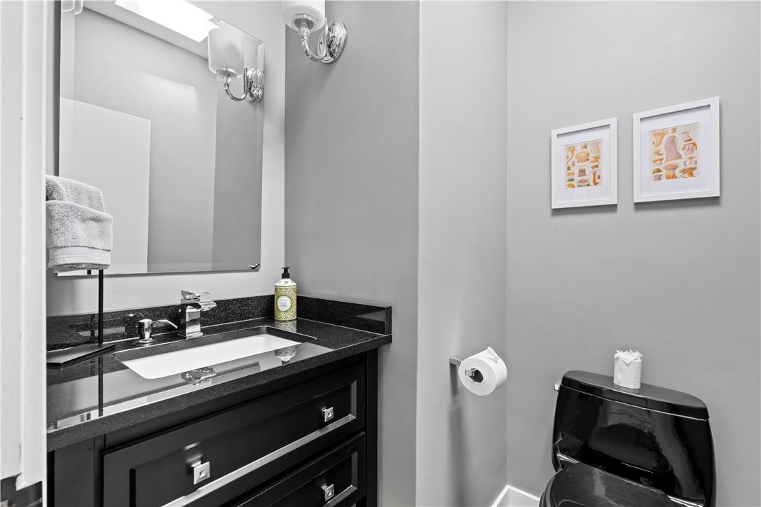 1506 Pleasant View Road Coopersburg, PA 18036 - Photo 61 of 97 A well-appointed bathroom features a dark vanity with a sleek granite counter and a modern toilet.