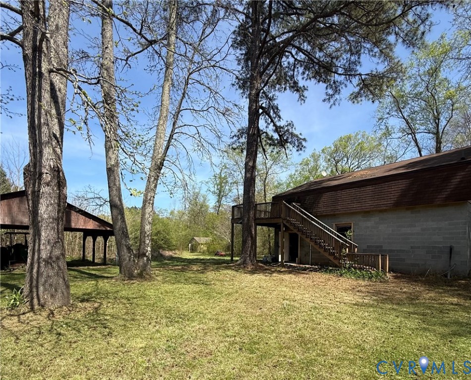 18318 Wards Creek Road Disputanta, VA 23842 - Photo 13 of 16 a view of house with backyard and trees