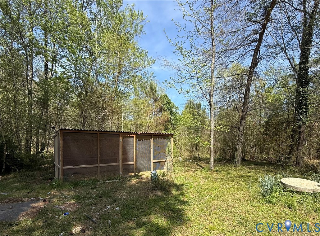 18318 Wards Creek Road Disputanta, VA 23842 - Photo 14 of 16 a backyard of a house with lots of green space
