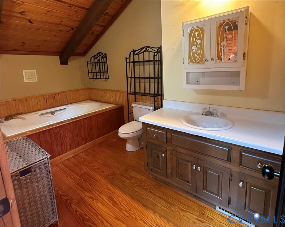 18318 Wards Creek Road Disputanta, VA 23842 - Photo 16 of 16 a bathroom with a sink a mirror and a toilet