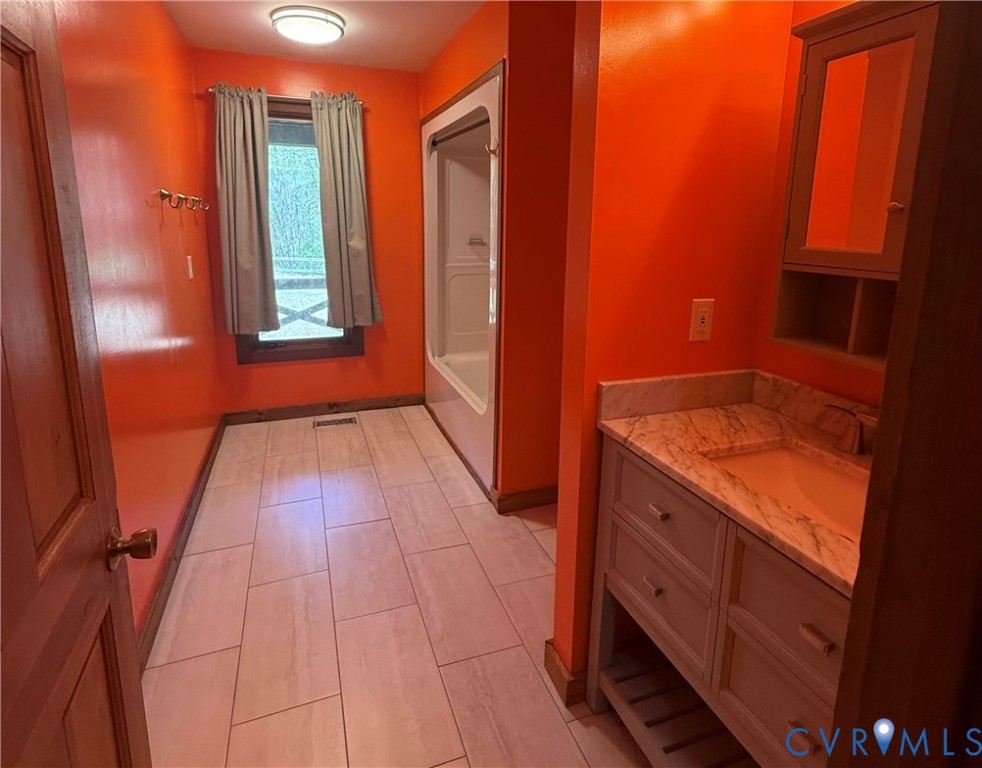 18318 Wards Creek Road Disputanta, VA 23842 - Photo 6 of 16 a view of hallway with window and wooden floor