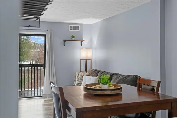 a view of a dining room with furniture and window