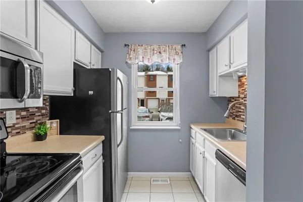 a kitchen with a refrigerator stove and sink