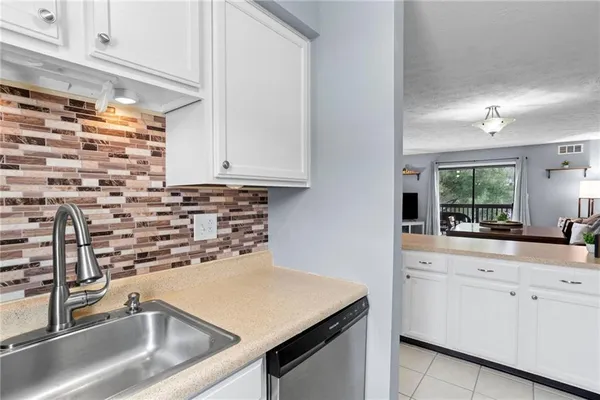 a kitchen with a sink and cabinets