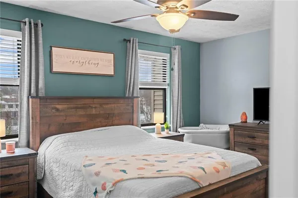 a bedroom with a bed and a flat screen tv