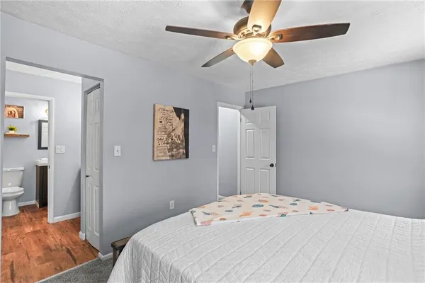 a bedroom with a bed and a chandelier