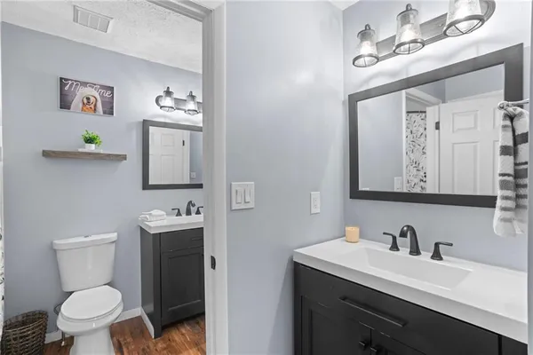 a bathroom with a toilet sink and mirror