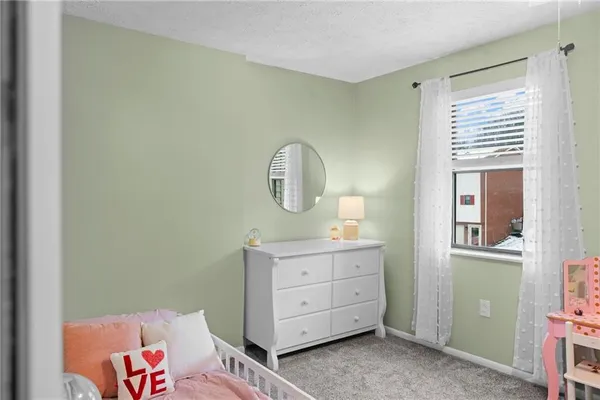 a bed room with a bed and a mirror