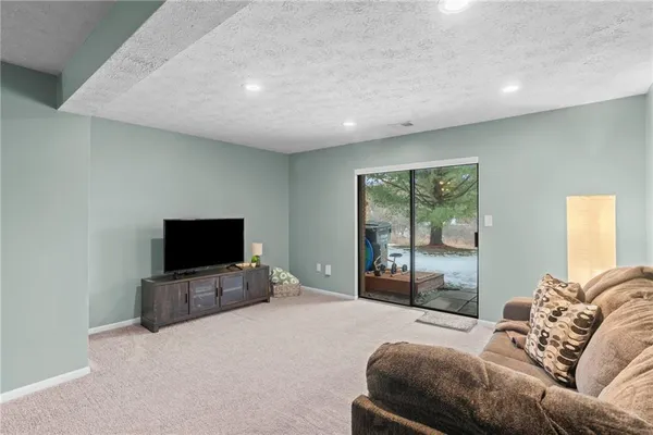 a living room with a flat screen tv and a couch