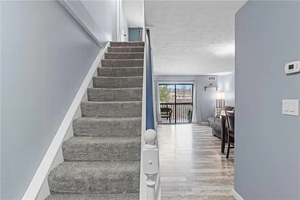 a view of staircase with white walls and windows