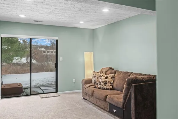 a living room with a couch and a glass door