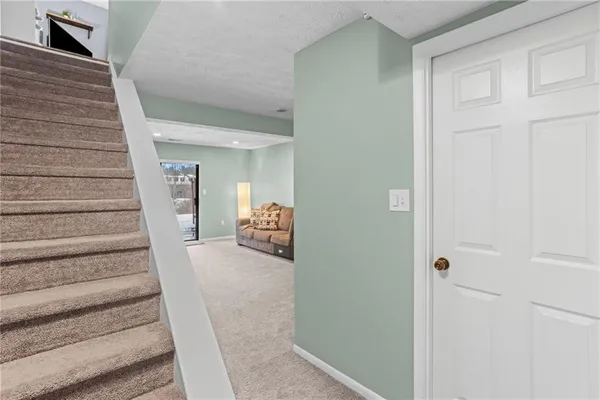 a view of entryway and hall with wooden floor