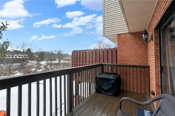 a view of a balcony with wooden floor