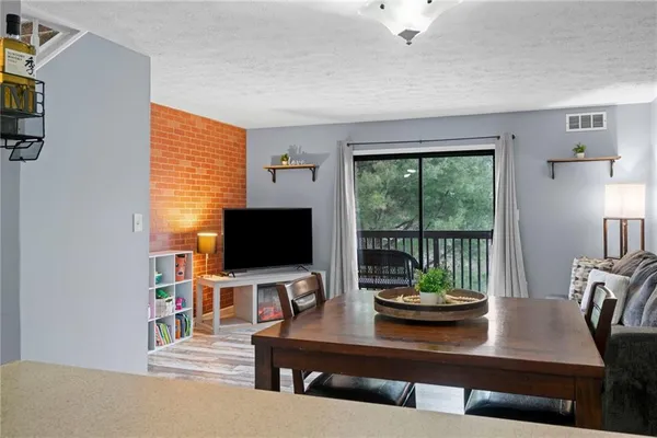 a view of a workspace with furniture and a flat screen tv