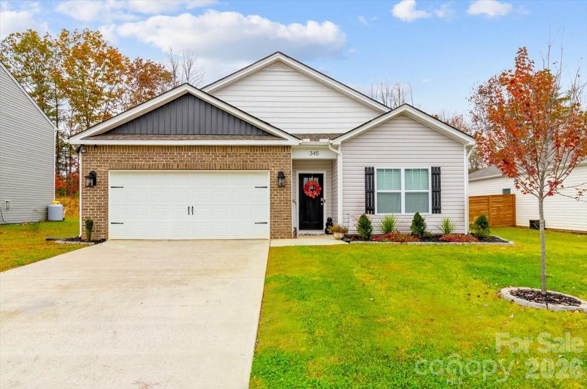 a view of a house with a yard and garage