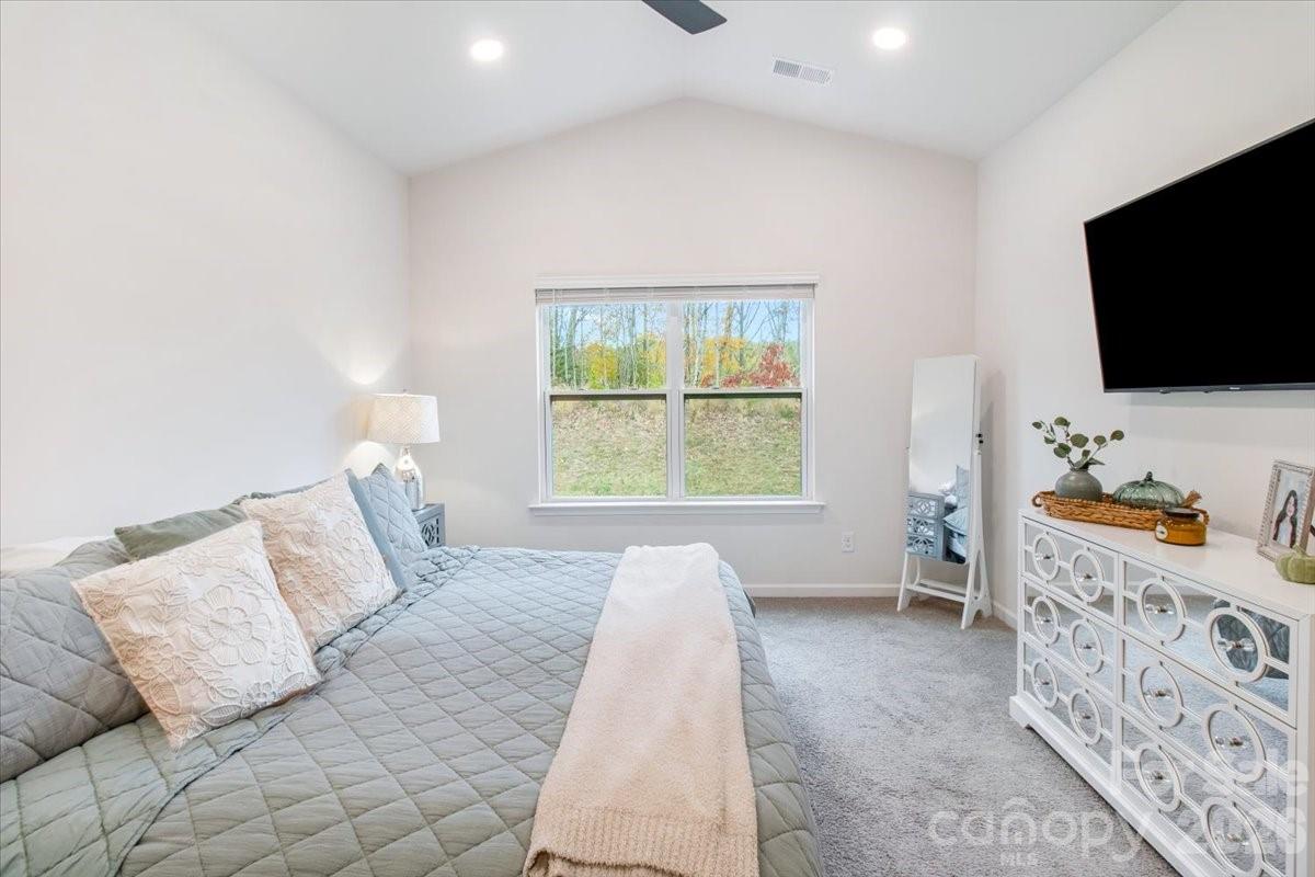 345 Ridgeview Lane Mars Hill, NC 28754 - Photo 6 of 13 a bedroom with a bed and a flat screen tv