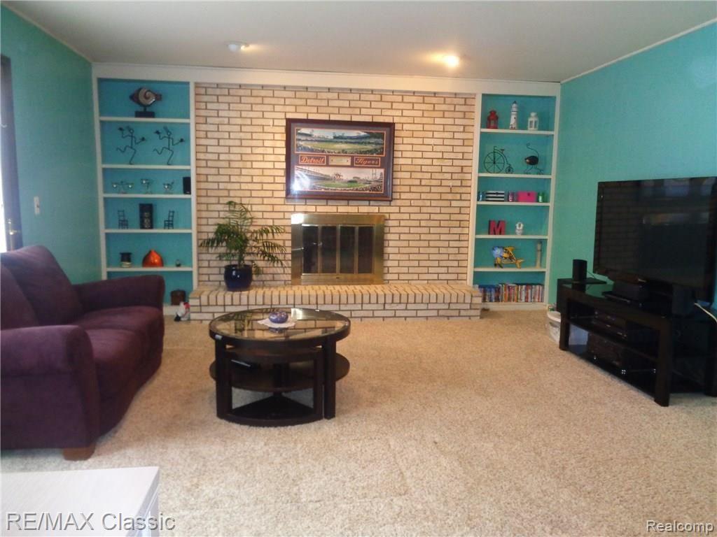 35235 Spring Hill Road Farmington, MI 48331 - Photo 10 of 28 CUSTOM BUILT IN SHELVING FLANK NATURAL HEARTH BRICK FIREPLACE