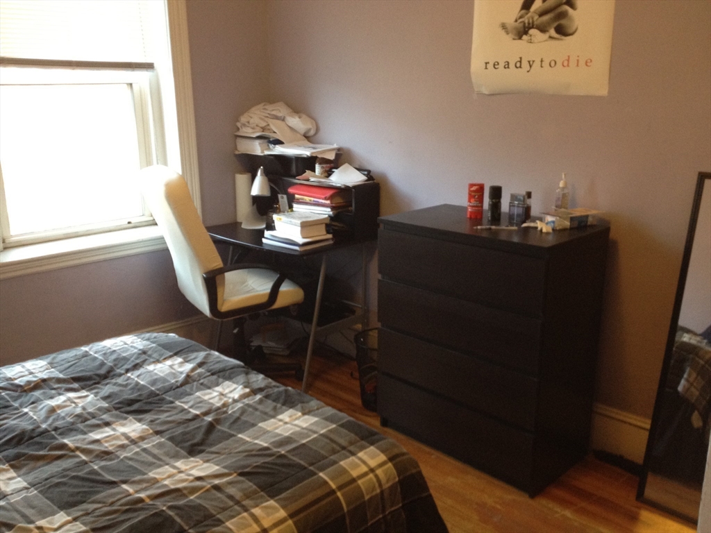 71 South Huntington Avenue, Unit 3 Boston, MA 02130 - Photo 9 of 11 a bedroom with a bed and a table in it